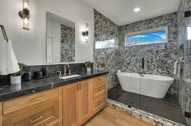 bathroom featuring hardwood / wood-style floors, plenty of natural light, and tile walls