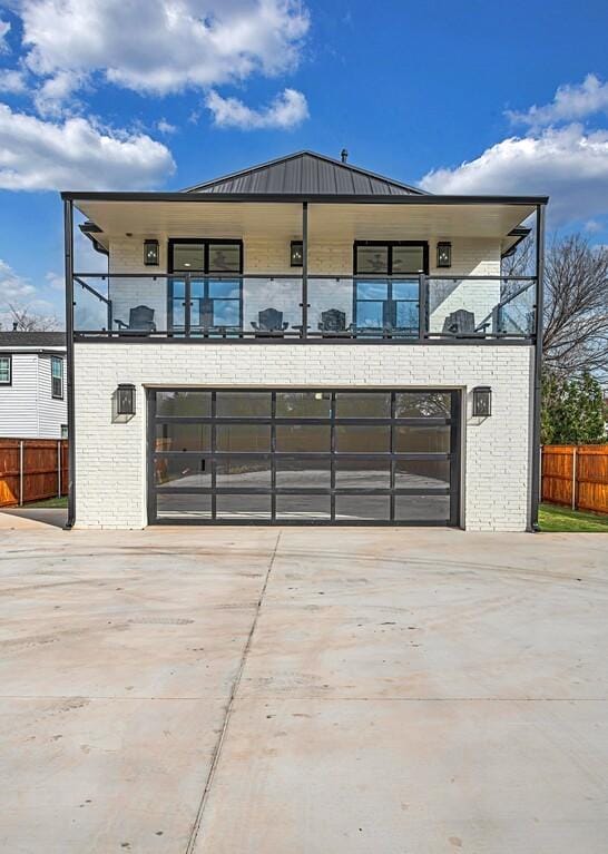 contemporary home featuring a balcony and a garage