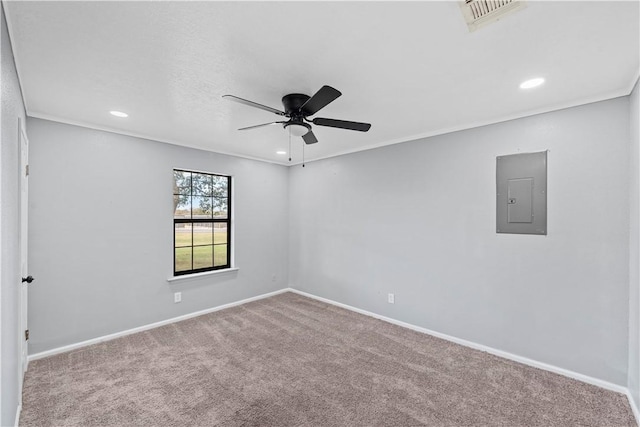 carpeted empty room with crown molding, electric panel, and ceiling fan