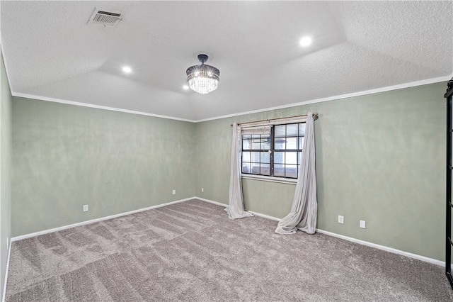 carpeted spare room with crown molding, a textured ceiling, and a notable chandelier