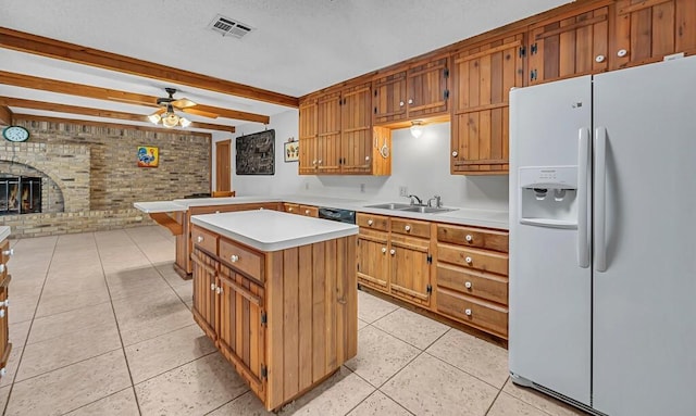 kitchen featuring sink, a center island, white fridge with ice dispenser, brick wall, and beamed ceiling