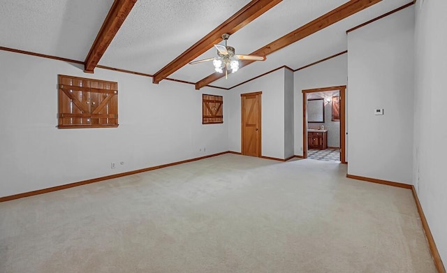 spare room with ceiling fan, a textured ceiling, light carpet, and vaulted ceiling with beams