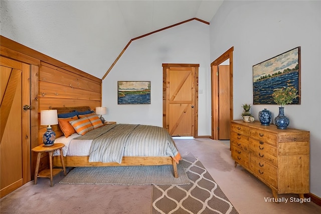 bedroom with high vaulted ceiling and light colored carpet