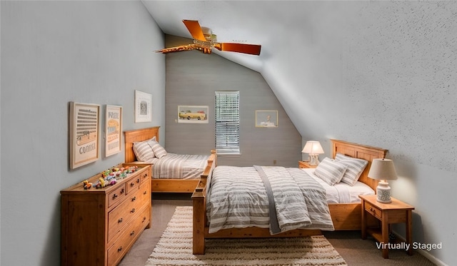 carpeted bedroom with vaulted ceiling and ceiling fan