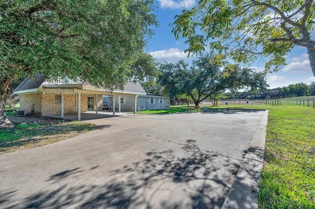 view of front of property featuring central AC and a front lawn