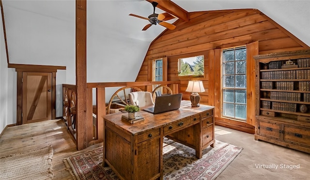 office space with plenty of natural light, light wood-type flooring, and vaulted ceiling with beams