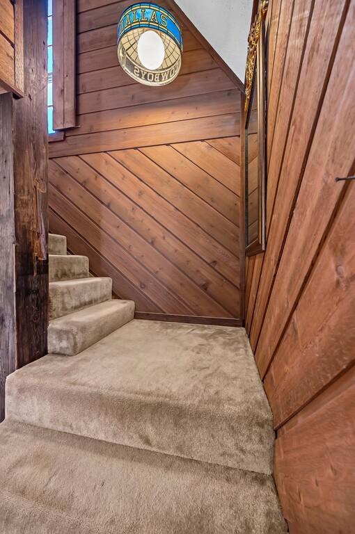 stairs featuring wooden walls