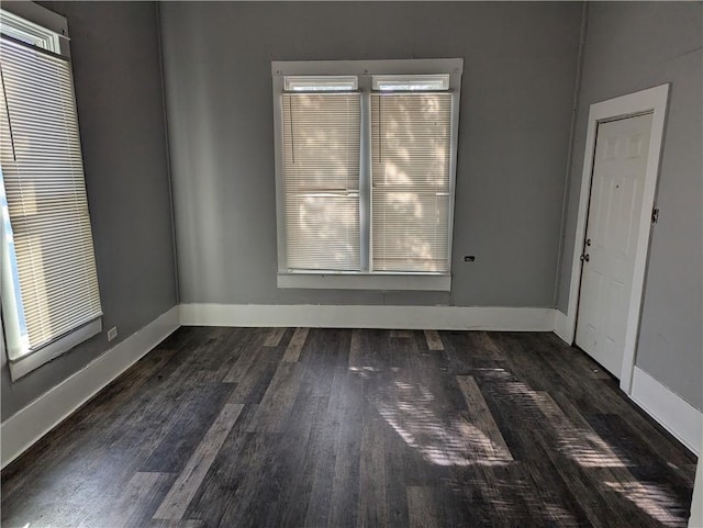 spare room with dark hardwood / wood-style floors