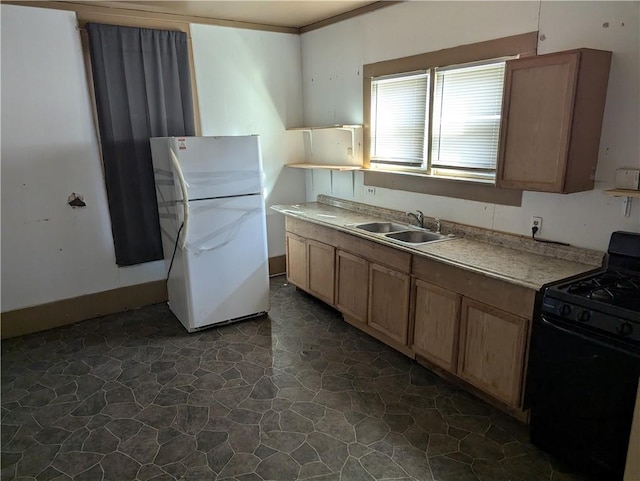 kitchen featuring white fridge, sink, and gas stove