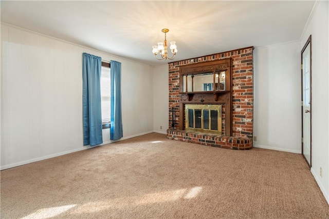 unfurnished living room with carpet, crown molding, a fireplace, and a chandelier