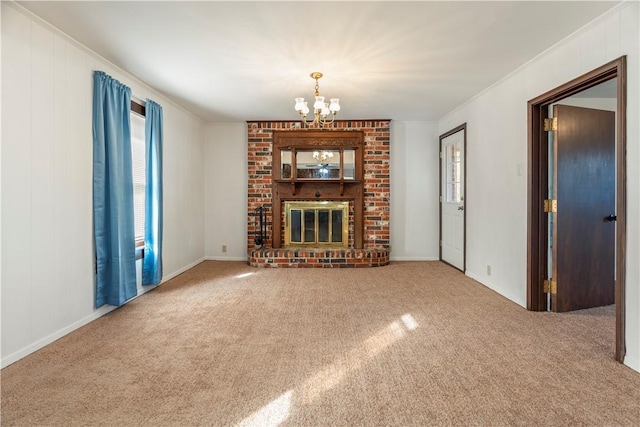 unfurnished living room with carpet, an inviting chandelier, a wealth of natural light, and a brick fireplace