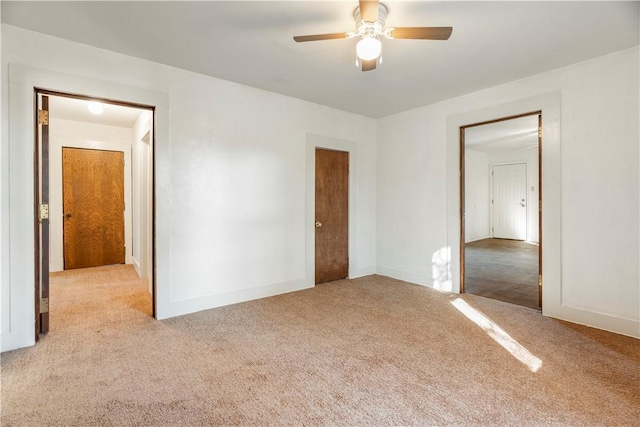 unfurnished bedroom with ceiling fan and light colored carpet