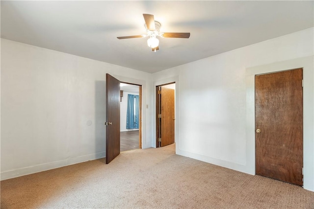 unfurnished bedroom with carpet flooring, ceiling fan, and a closet