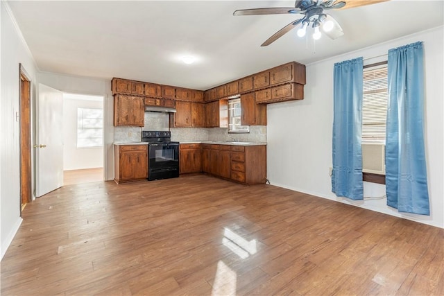 kitchen featuring backsplash, black / electric stove, ceiling fan, and light wood-type flooring