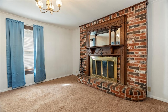 unfurnished living room with carpet flooring, an inviting chandelier, a fireplace, and crown molding