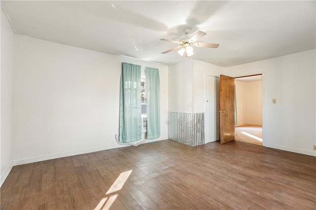 empty room featuring hardwood / wood-style flooring and ceiling fan