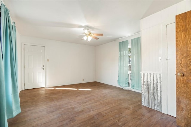 empty room featuring ceiling fan and dark wood-type flooring