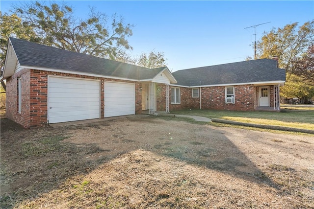 single story home featuring a front yard and a garage