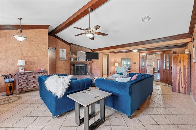 living room with vaulted ceiling with beams, a fireplace, and light tile patterned floors