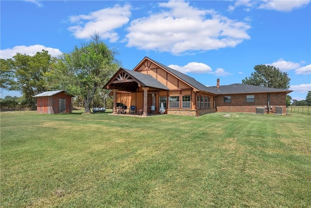 back of property with a lawn and a shed