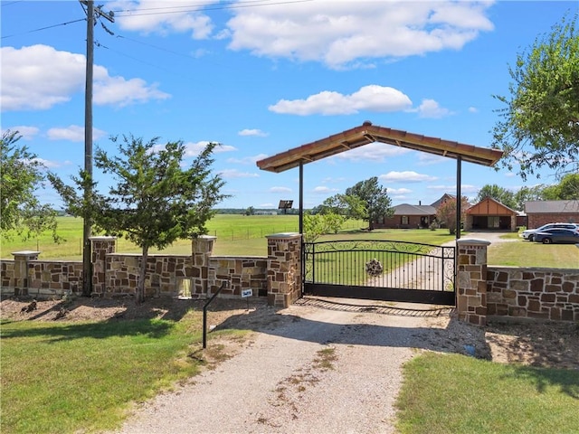 view of gate featuring a lawn