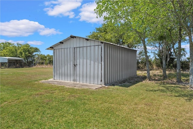 view of outbuilding with a lawn