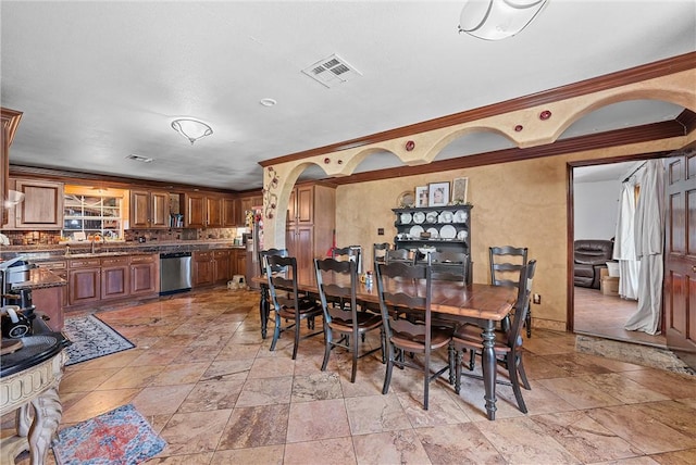 dining space featuring ornamental molding