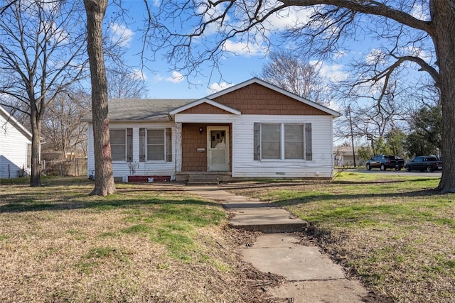 bungalow-style home featuring a front yard