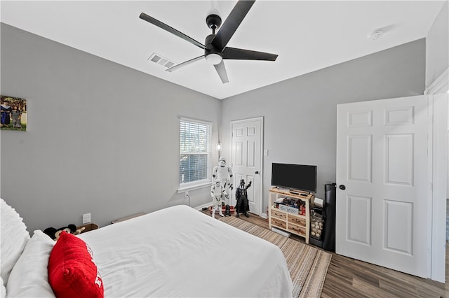 bedroom with ceiling fan and hardwood / wood-style flooring