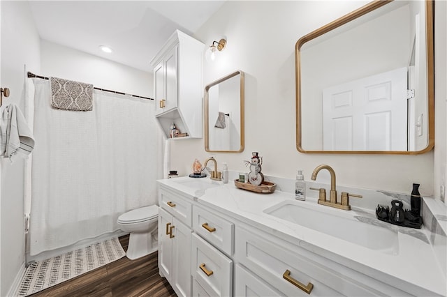 full bathroom with hardwood / wood-style floors, vanity, toilet, and shower / bath combination with curtain