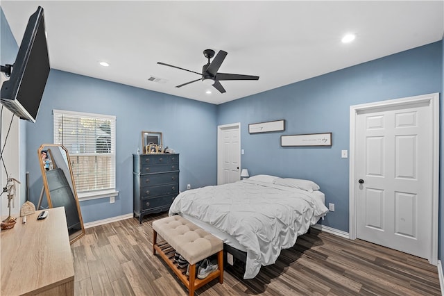 bedroom with ceiling fan and dark hardwood / wood-style floors