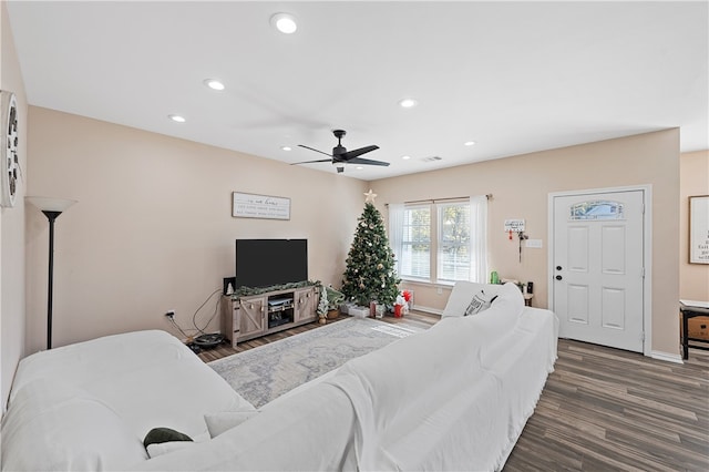 living room with ceiling fan and dark hardwood / wood-style flooring