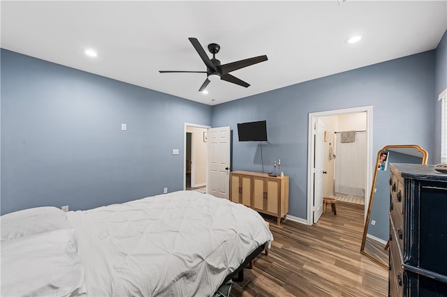 bedroom featuring ceiling fan, ensuite bathroom, and dark hardwood / wood-style floors