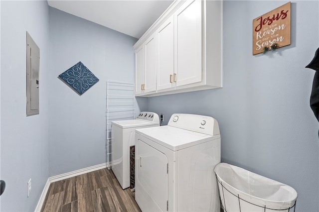 clothes washing area with electric panel, dark hardwood / wood-style flooring, cabinets, and independent washer and dryer