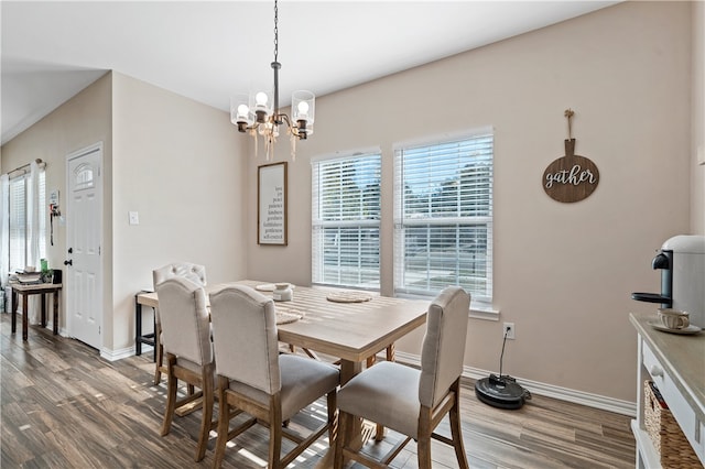 dining room featuring hardwood / wood-style floors and an inviting chandelier