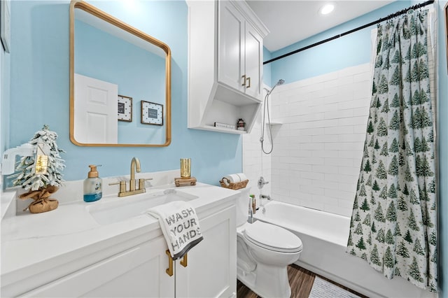 full bathroom featuring hardwood / wood-style floors, vanity, toilet, and shower / bath combo with shower curtain