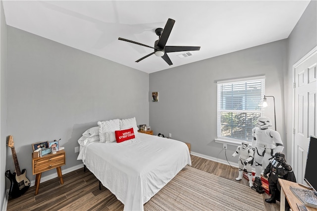 bedroom with ceiling fan and dark hardwood / wood-style floors