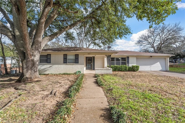 ranch-style home with concrete driveway, brick siding, and an attached garage