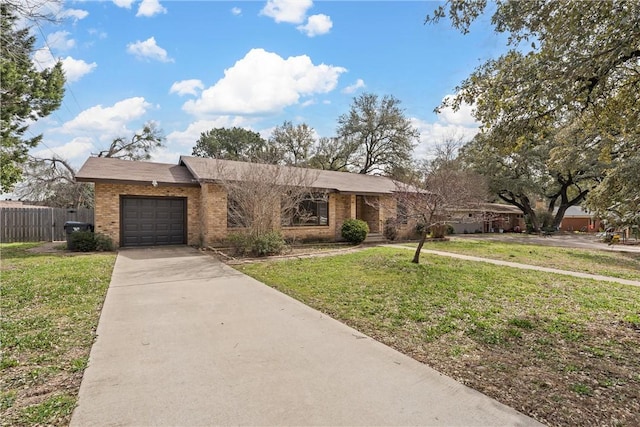 view of front of property featuring brick siding, concrete driveway, an attached garage, fence, and a front lawn