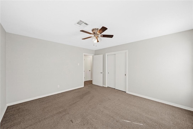 unfurnished bedroom with carpet, a closet, visible vents, and baseboards