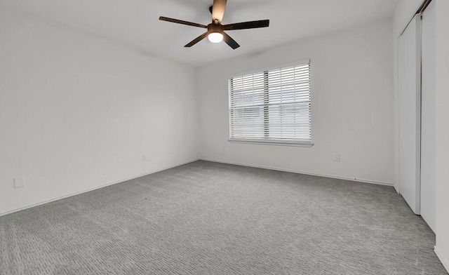 unfurnished bedroom featuring a closet, carpet flooring, and a ceiling fan