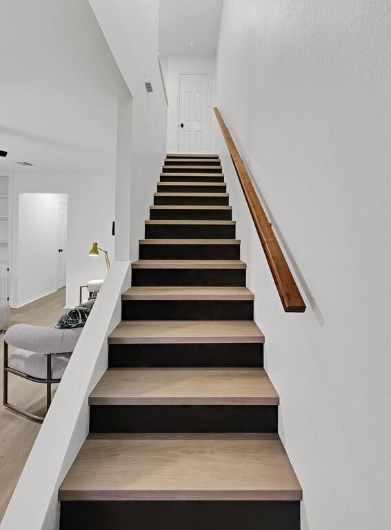 stairway featuring wood finished floors