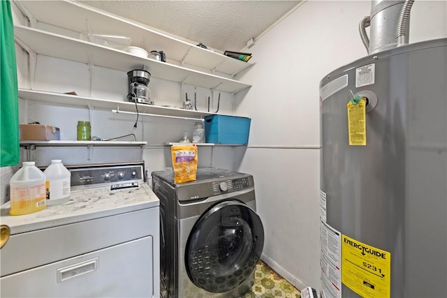 washroom with water heater, washer and dryer, and a textured ceiling