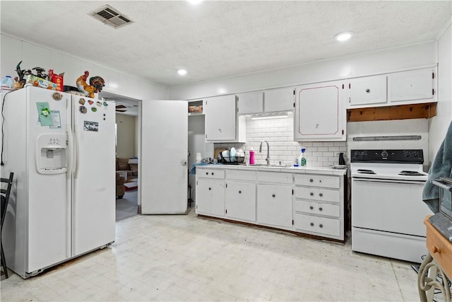 kitchen with white appliances, backsplash, sink, a textured ceiling, and white cabinetry