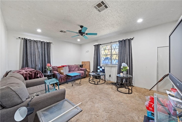 carpeted living room featuring a textured ceiling and ceiling fan