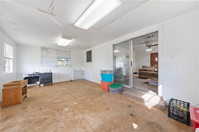 basement with plenty of natural light and ceiling fan