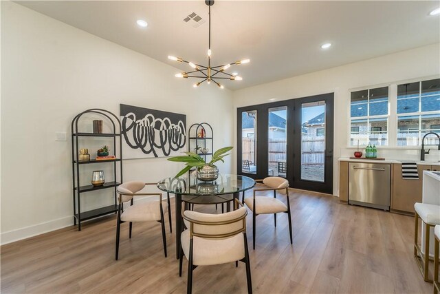 dining space featuring a chandelier and light wood-type flooring