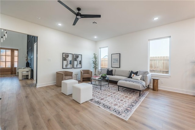 living room featuring ceiling fan and light wood-type flooring