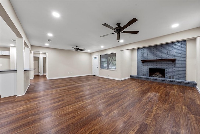 unfurnished living room featuring a brick fireplace, a ceiling fan, wood finished floors, and recessed lighting