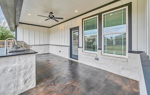 view of patio with ceiling fan, sink, and an outdoor kitchen